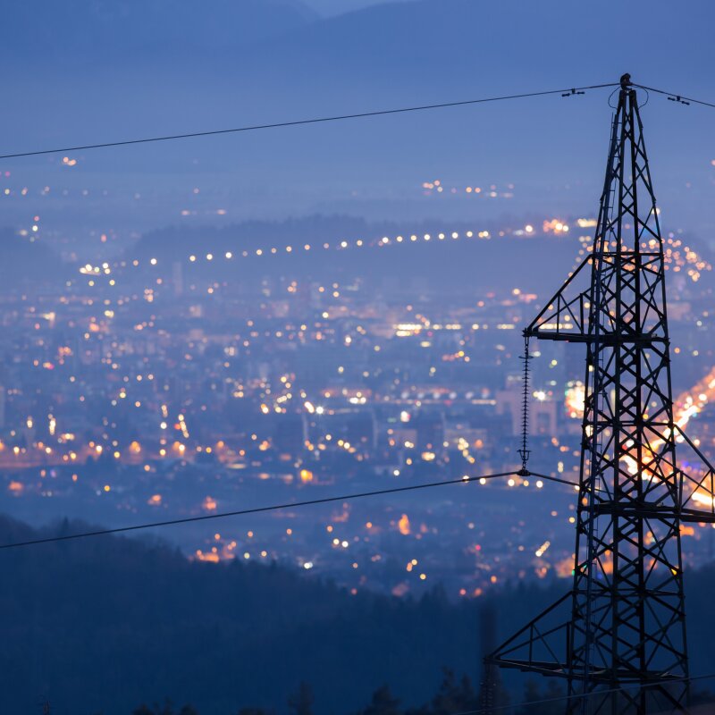 Transmission-line-with-city-lights.jpg